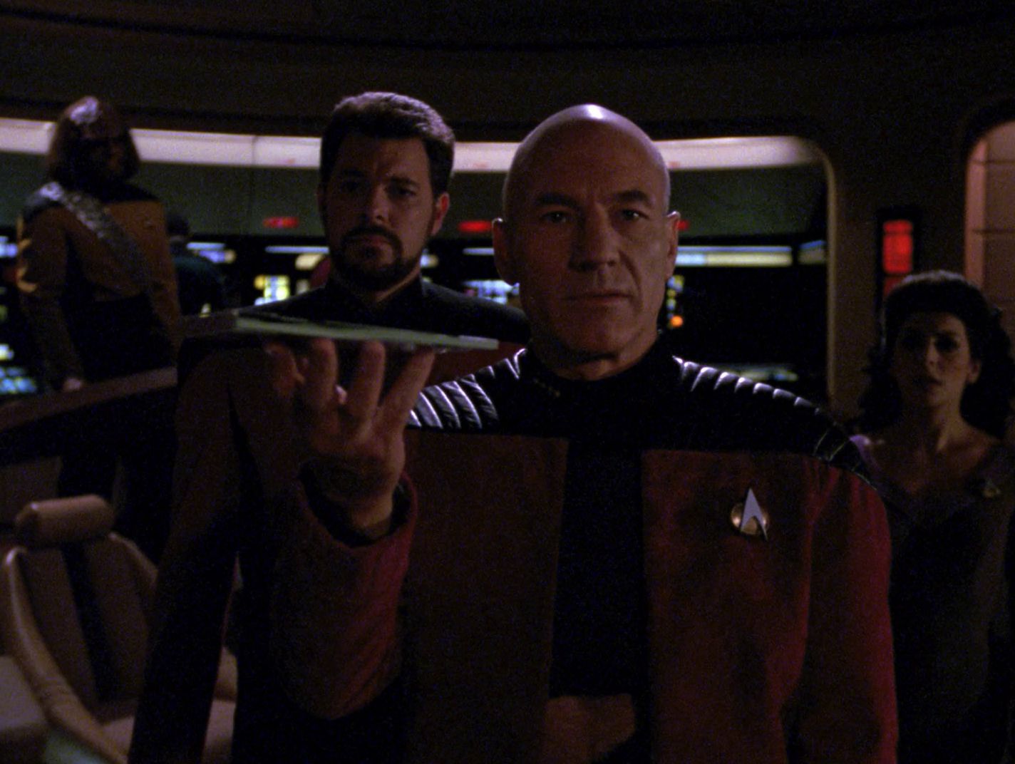 Picard holds up the Tamarian captain's journal, and the Tamarians transport it back to their ship.