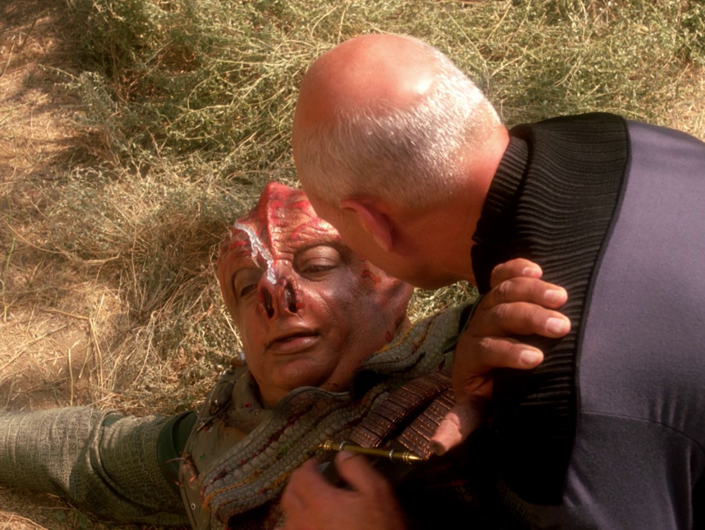 Picard rushes to help the injured Tamarian captain.